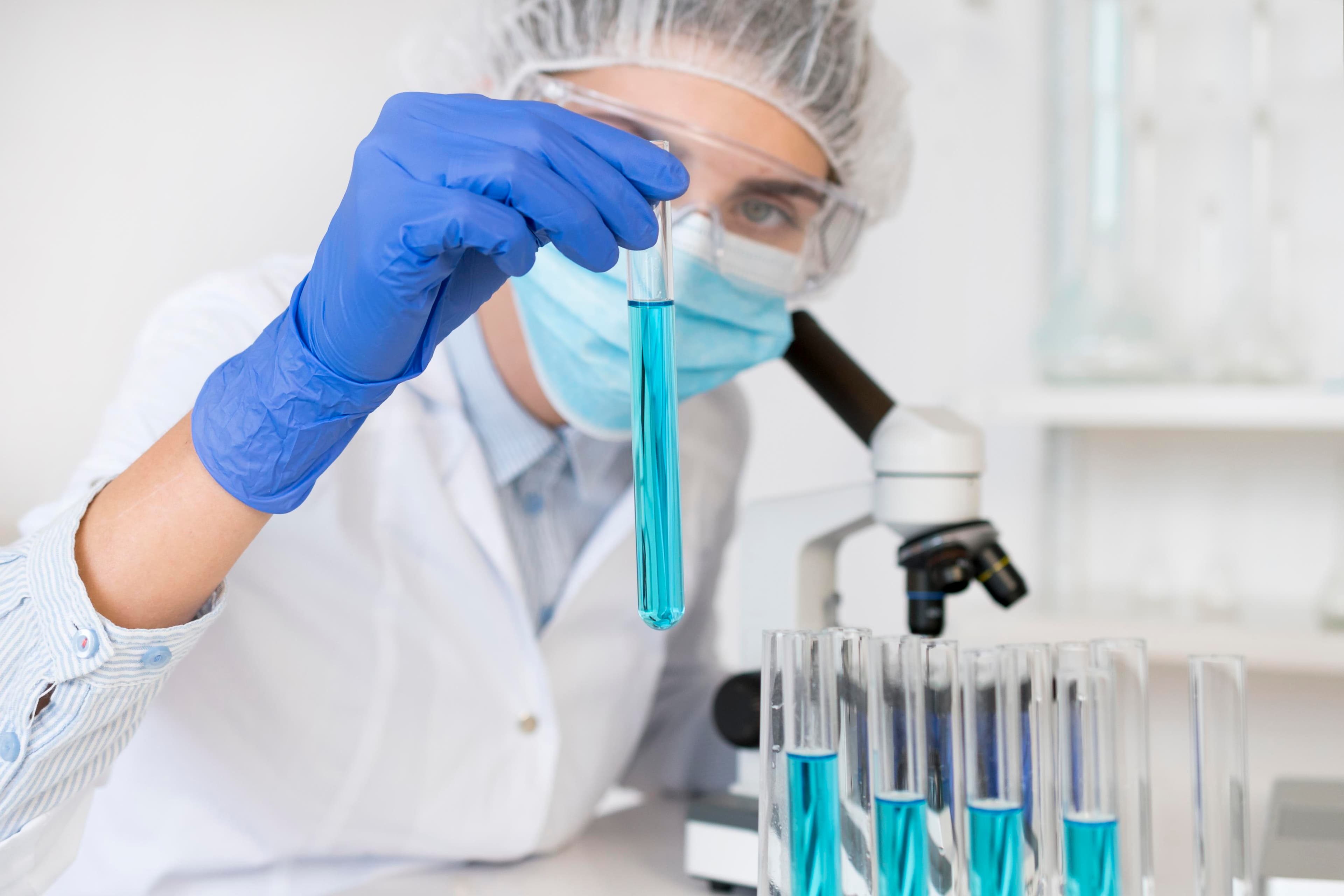 Pharma scientist performing microscope quality checks